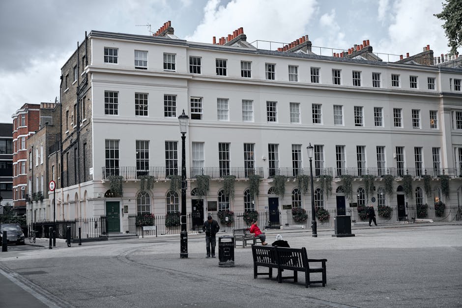 The image shows a historic, multi-story corner building in Bloomsbury with ornate architectural details, red brick and stone facades, and large windows. The ground floor features a traditional pub wit